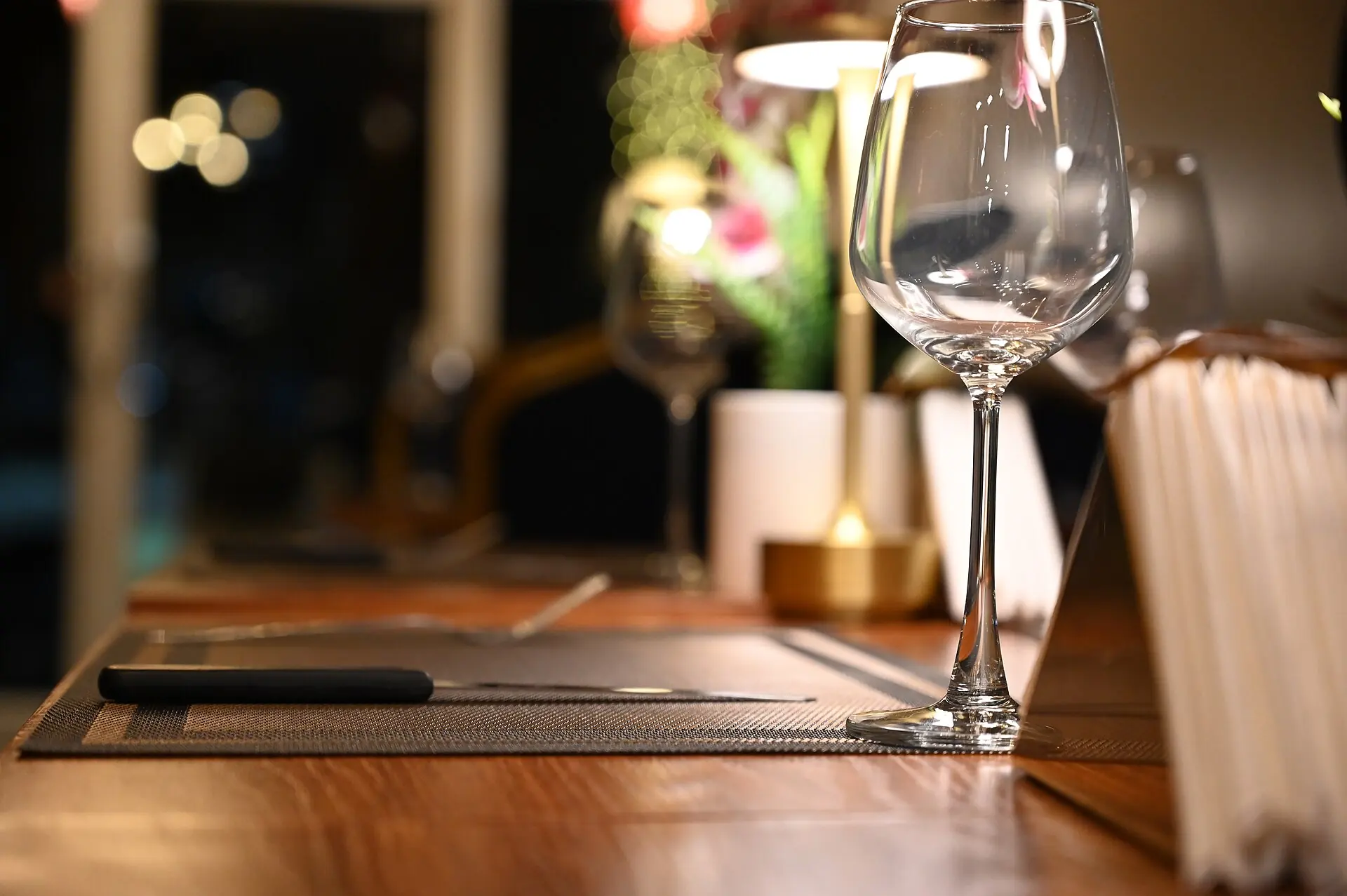 Elegant dinner table setting in warm candlelight